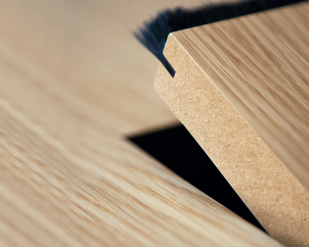 A close-up of a wooden Tempest tabletop with a hinge