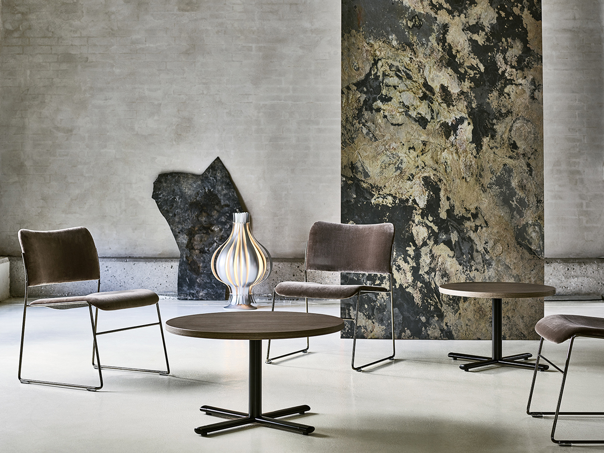 An installation image with 3 upholstered 40/4 lounge chairs and two round Tempest lounge tables