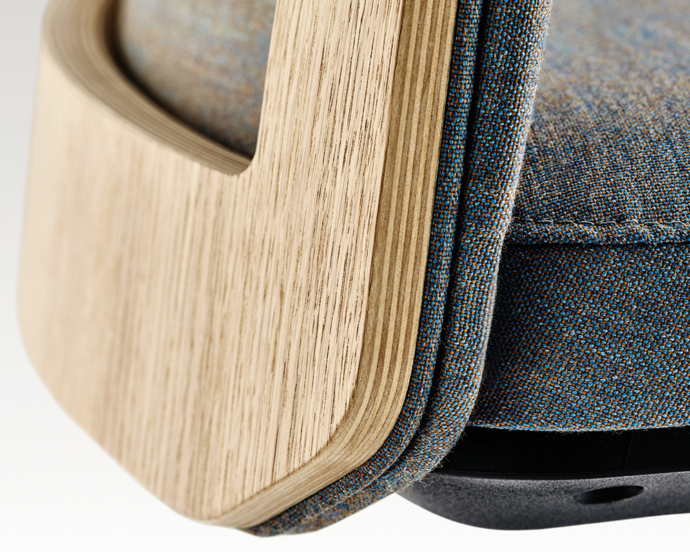 A close-up of an MN1 chair with an oak veneer frame