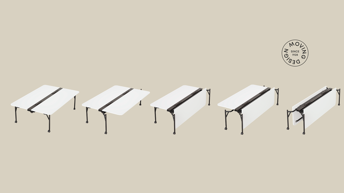 The White Folding Surfaces bench desk unfolds gradually against a sandy background