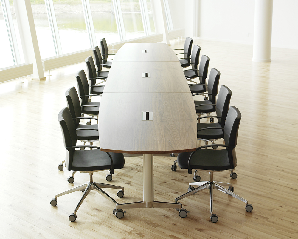 A Moveo conference table with black chairs in a room