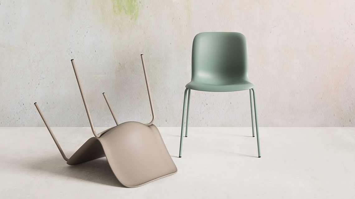 An installation of two SixE chairs in front of a painted wall