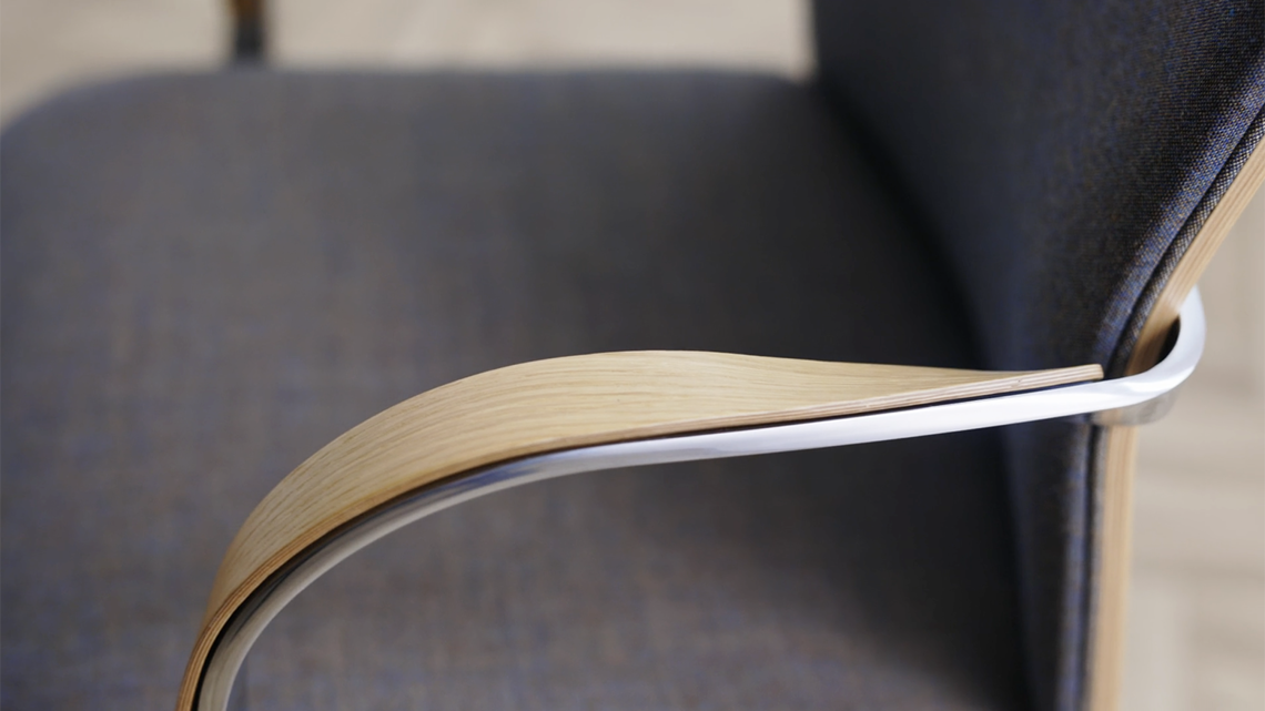 A detailed image of the armrest and seat of the MN1 chair