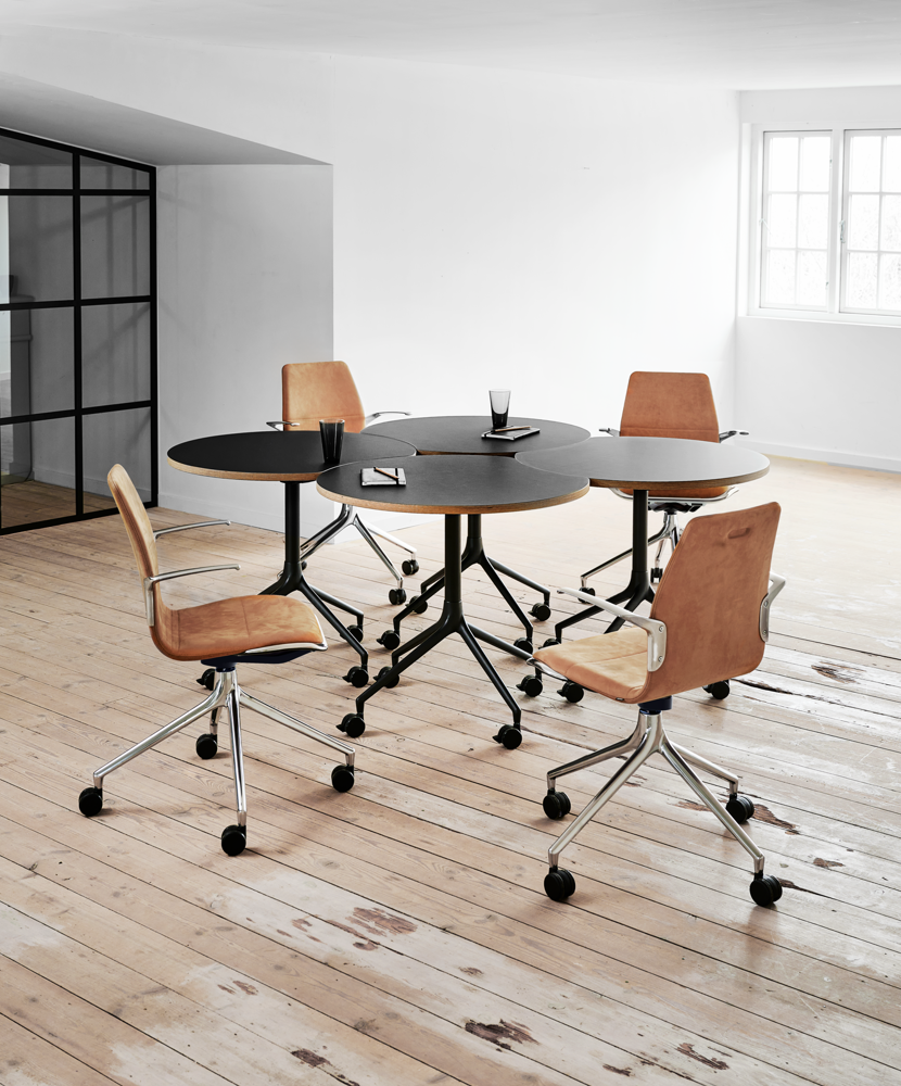 An installation image of four AS400 round-concave tables and four AS100 chairs