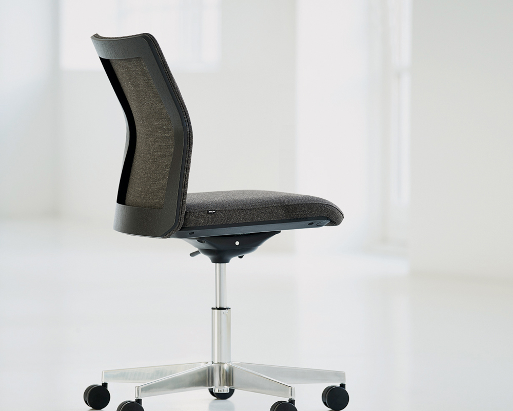 A black back MN1 5-star office chair in an empty room