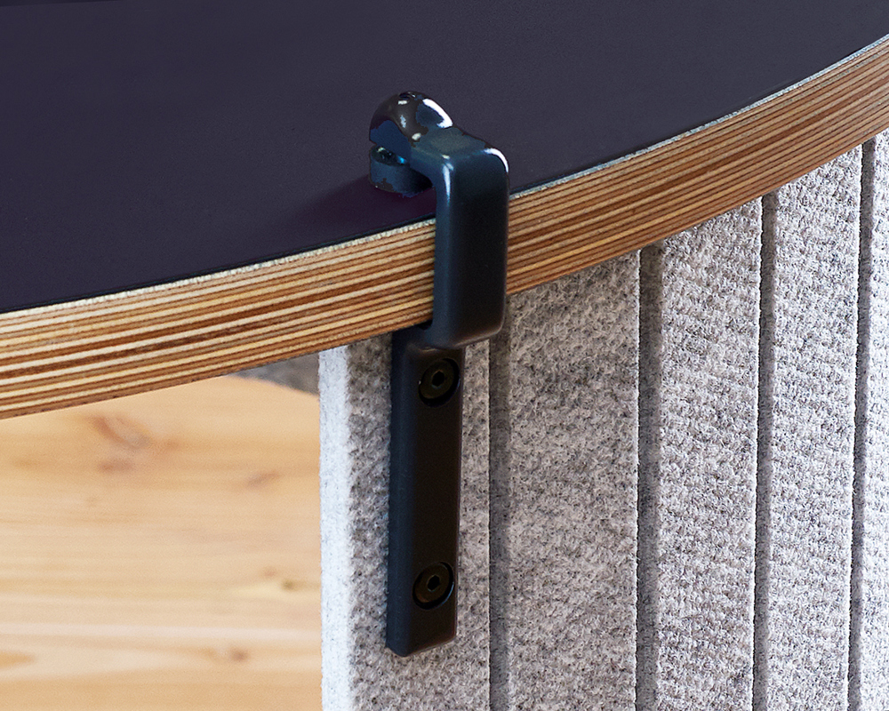 A closeup image of a round AS400 table, with a privacy screen and clamp detail