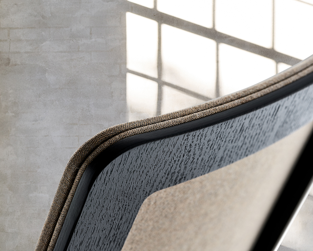 A close-up of an MN1 chair with a black stained oak veneer frame