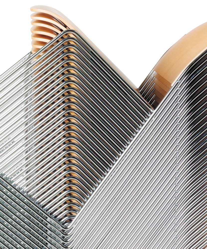 A close-up image of a stack of veneer 40/4 chairs 