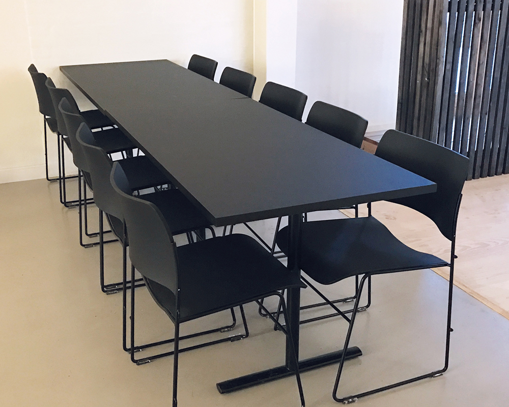 A black Tempest table with black 40/4 chairs around it