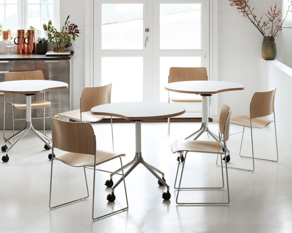 A group of 40/4 veneer chairs and AS400 white tables in a kitchen/canteen area