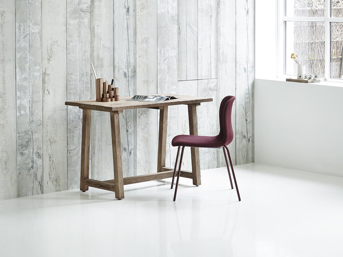 An installation image with SixE upholstered chair and a wooden desk